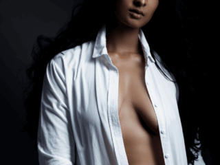 Stunningly feminine boudoir shot with woman with white shirt taken in studio by Loci Photography