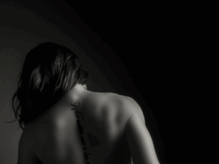 The back shot being a hero again during a boudoir shoot in studio by Loci Photography.