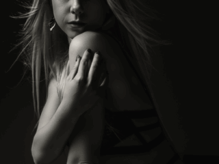 The female lines being showcased sensually during a boudoir shoot done in studio by Loci Photography.
