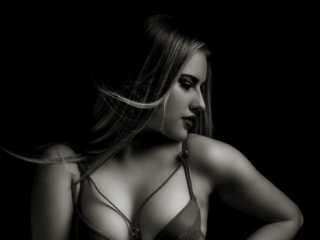 Black and white moody image taken in studio for a boudoir shoot done by Pretoria photographer Yolandi Jacobsz of Loci Photography