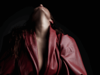 Using the Nicolassi redd coat in a gorgeous sensual pose during a Loci Photography boudoir shoot.