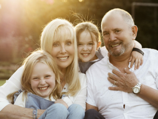 Families smiling during their sunset photoshoot with Loci Photography