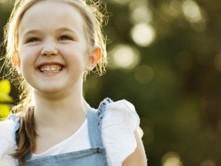 Smiling girl during a family photoshoot by Loci Photography