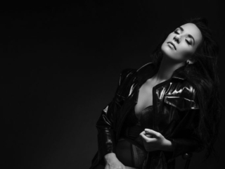 Black and white boudoir image of woman in black leather coat by Loci Photography in Pretoria