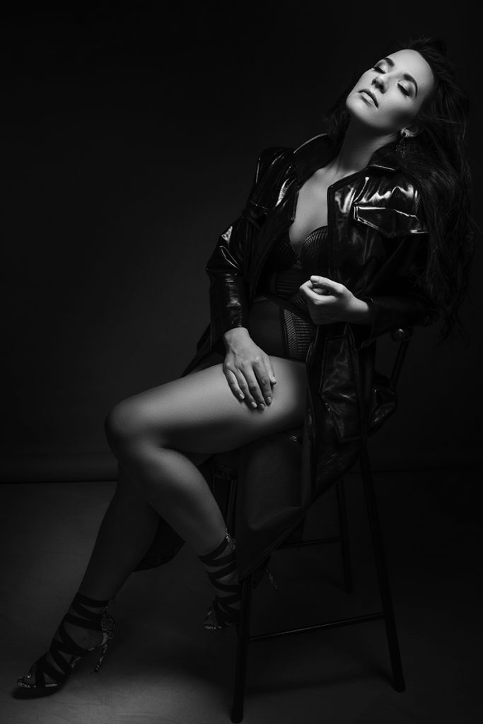 Black and white boudoir image of woman in black leather coat by Loci Photography in Pretoria
