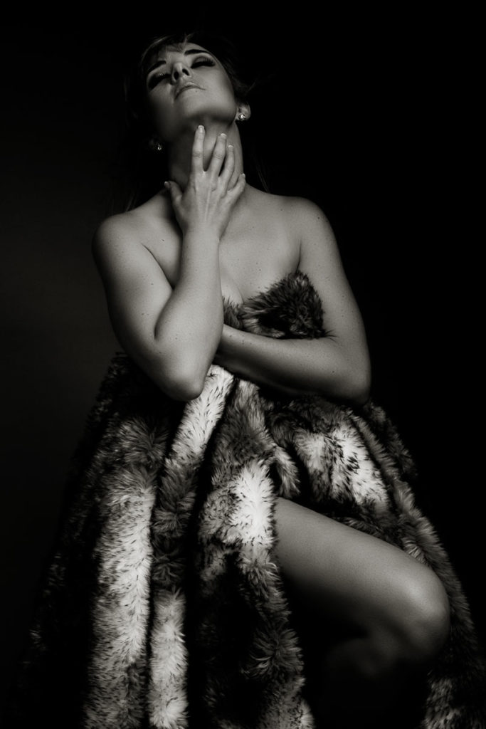 Black and white moody image taken in studio for a boudoir shoot done by Pretoria photographer Yolandi Jacobsz of Loci Photography