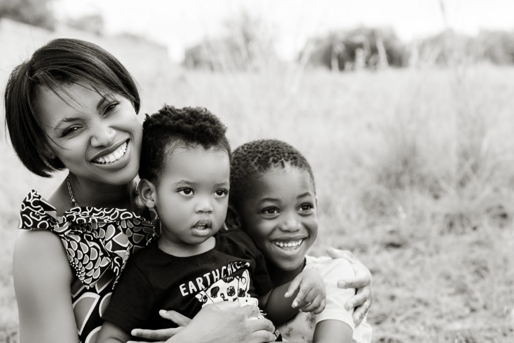 Image of smiling mommy and kids during a family photoshoot in Hartbeespoort by Loci Photography
