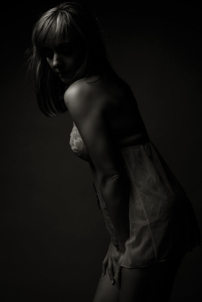 Black and white moody image taken in studio for a boudoir shoot done by pretoria photographer Yolandi Jacobsz of Loci Photography