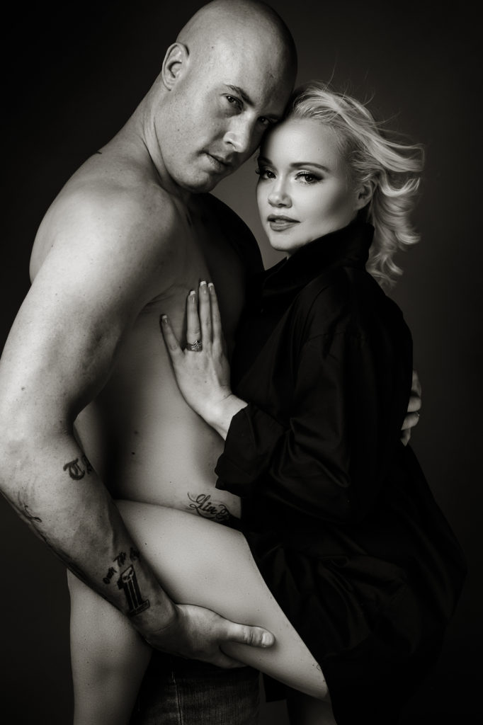 Black and white couple boudoir image taken in studio by photographer Yolandi Jacobsz of Loci Photography
