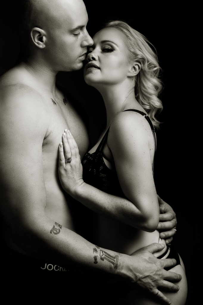 Black and white couple boudoir image taken in studio by photographer Yolandi Jacobsz of Loci Photography
