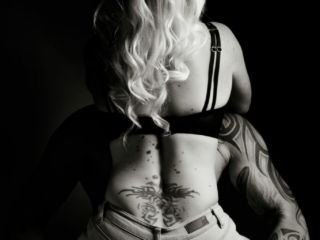 Black and white couple boudoir image taken in studio by photographer Yolandi Jacobsz of Loci Photography