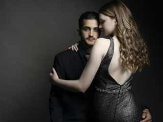 Image of girl sitting on guy&#039;s lap during a studio matric dance photoshoot by Loci Photography