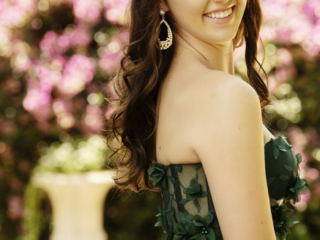 Image of young girl in dark green dress with pink background for her matric dance photoshoot by Loci Photography