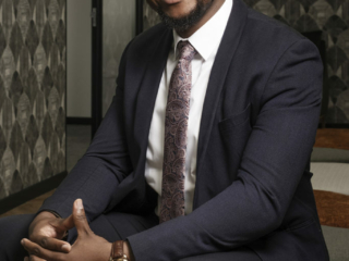 Image of man sitting with blue suit and tie captured professional for corporate photography done by Loci Photography