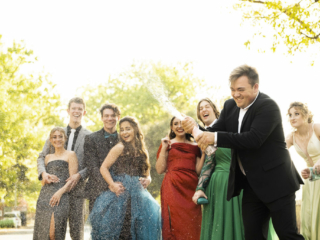 Group shot of popping champagne during matric dance photoshoot by Loci Photography