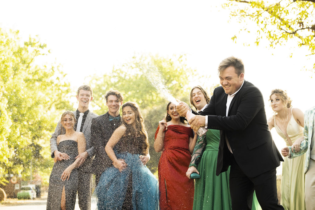 Group shot of popping champagne during matric dance photoshoot by Loci Photography