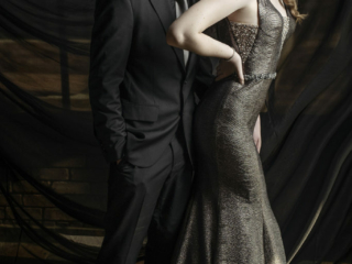 Studio image of couple in black suit and dark silver dress for a matric dance photoshoot taken in studio by Loci Photography
