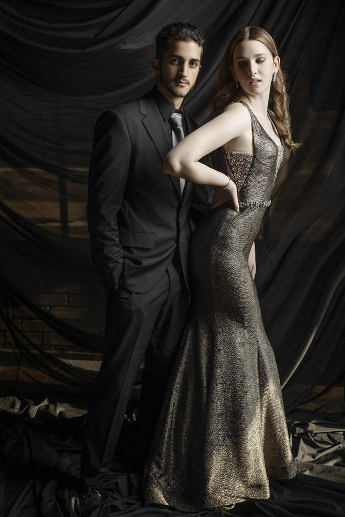 Studio image of couple in black suit and dark silver dress for a matric dance photoshoot taken in studio by Loci Photography