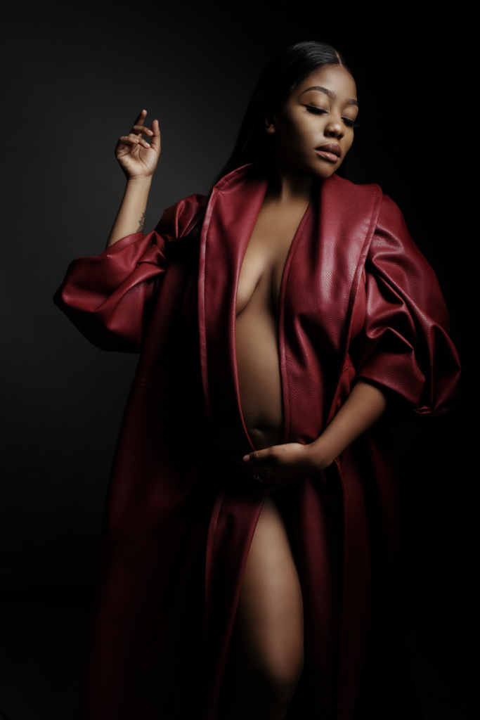 Image of using the red leather Nicolassi coat for a maternity shoot in the Loci Photography studio.