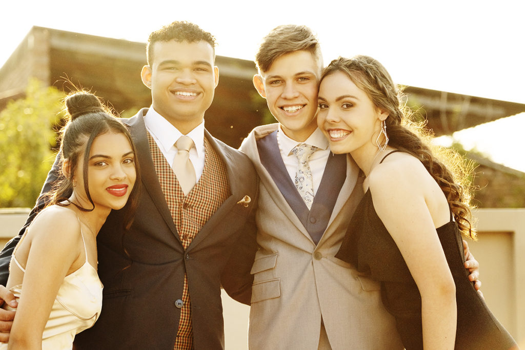 Image of group smiling in evening dress during their matric dance photoshoot by Loci Photography