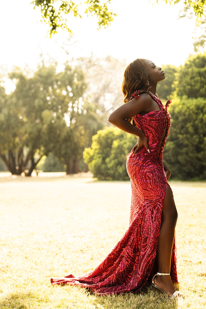 Outside image of girl in dark pink dress taken at the Pretoria Botanical Gardens during a matric dance photoshoot by Loci Photography