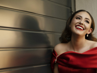 Young woman in red dress and red lips smiling during her matric dance photoshoot by Loci Photography