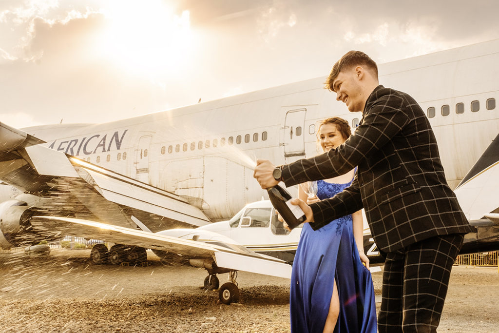 Popping some champagne in the late afternoon sun at a professional matric dance photoshoot at Rand Airport in Germiston done professionally by Loci Photography
