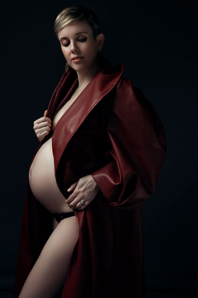 Stunning moody maternities using the red Nicolassi coat by Loci Photography.