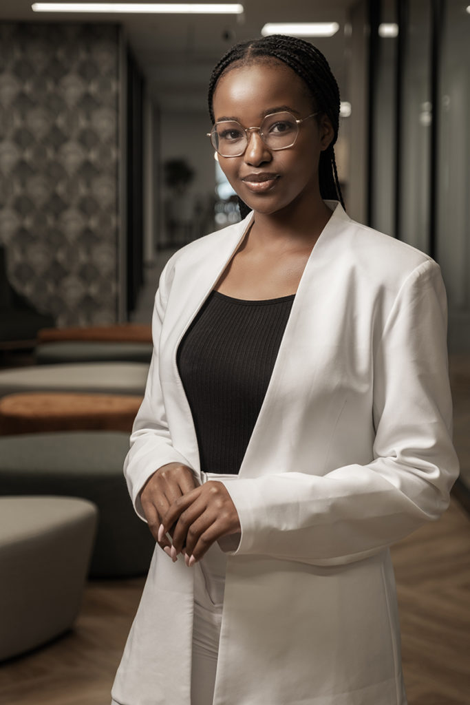 Corporate image of woman with glasses and white suit photographed by Loci Photography