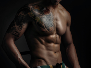 Moody fitness image of trained man with well shaped physique during fitness photoshoot with Loci Photography