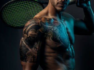 Moody fitness image of trained man with tennis racket with well shaped physique during fitness photoshoot with Loci Photography