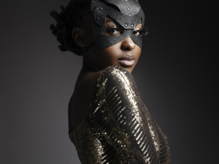 Female model in gold shimmer glitter dress with black glitter bunny mask photographed in studio by Loci Photography