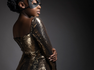Female model in gold shimmer glitter dress with black glitter bunny mask photographed in studio by Loci Photography