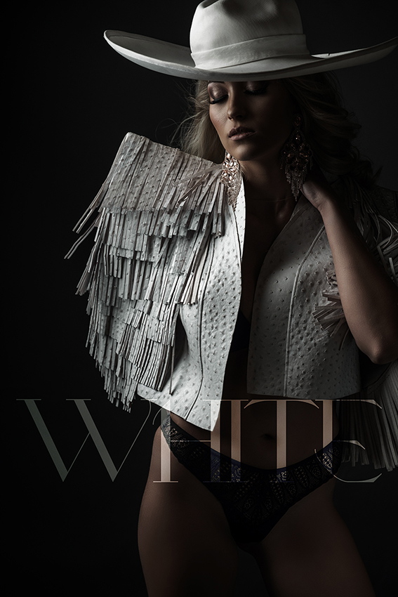 The white fringe jacket from The Nicolassi Brand as well as an incredible white hat for a boudoir shoot