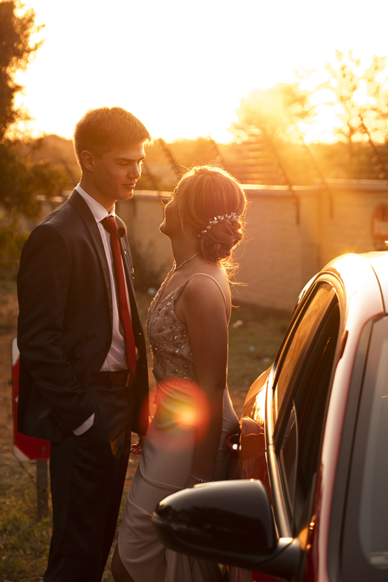 Sunset image of couple right before they leave for their matric dance captured by Loci Photography