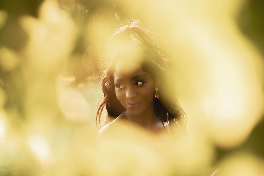 Image of girl looking through leaves at sunset during her matric dance photoshoot by Loci Photography